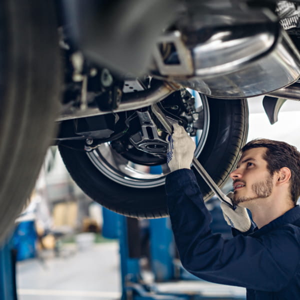 Photo of a mechanic repairing car engine